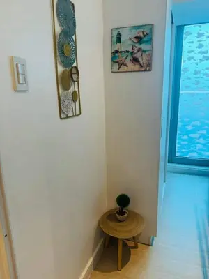 a hallway with a small table and a window at Azure Urban Resort in Manila