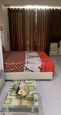 a bedroom with a bed and a table in front of it at Azure Urban Resort in Manila