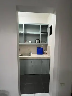 a kitchen with a sink and white cabinets at Casa Emerita in Santa Rosa