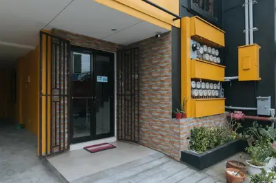 an entrance to a brick building with a yellow door at 4720 Silverio Suites Paranaque City in Manila