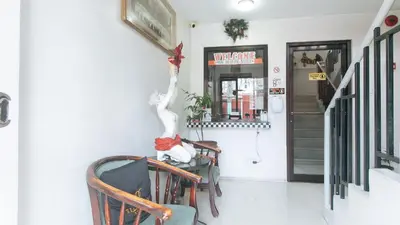 a room with two chairs and a wall at 4720 Silverio Suites Paranaque City in Manila