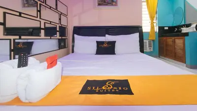 a hotel room with a bed with a sign on it at 4720 Silverio Suites Paranaque City in Manila