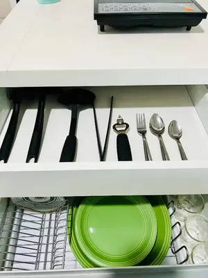 a drawer with a plate and utensils in it at Azure Positano Tower Beach Vibe in Manila