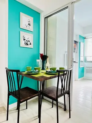 a dining room with a table and two chairs at Azure Positano Tower Beach Vibe in Manila