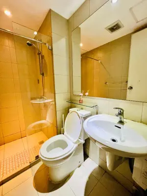 a bathroom with a toilet and a sink at Scr Summer Vibe Netflix Balcony in Manila