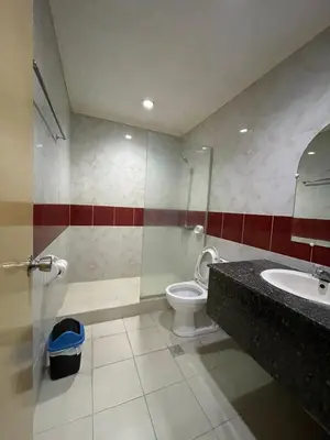 a bathroom with a toilet and a sink at Town and Country Hotel V Mapa in Manila
