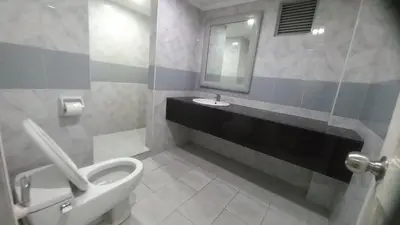 a bathroom with a toilet and a sink at Town and Country Hotel V Mapa in Manila