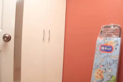 a white cabinet next to a door with a bag at A2J BGC Luxury 2BR Loft Near Burgos Circle, Malls in Manila