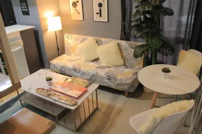 a living room with a couch and a table at A2J BGC Luxury 2BR Loft Near Burgos Circle, Malls in Manila