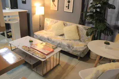 a living room with a couch and a table at A2J BGC Luxury 2BR Loft Near Burgos Circle, Malls in Manila