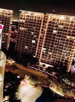 a view of a city at night with tall buildings at AZURE A6 beachpool with Balcony Wifi near mall airport in Manila
