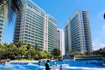 a group of people in the water at a resort at AZURE A6 beachpool with Balcony Wifi near mall airport in Manila