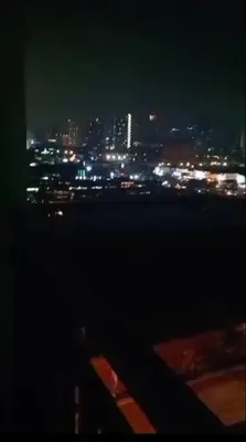 a view of a city at night with lights at MOA Shore 2 1BR with Balcony WiFi Netflix Pool 4Pax in Manila