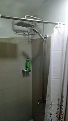 a shower in a bathroom with a shower curtain at MOA Shore 2 1BR with Balcony WiFi Netflix Pool 4Pax in Manila