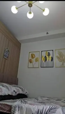 a bedroom with a bed and pictures on the wall at MOA Shore 2 1BR with Balcony WiFi Netflix Pool 4Pax in Manila