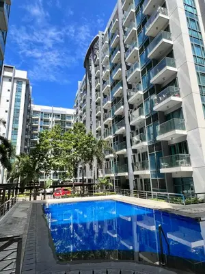 a swimming pool in front of a building at Studio at Newport World Airport Area Prime Location in Manila