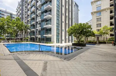 a swimming pool in front of a tall building at Studio at Newport World Airport Area Prime Location in Manila