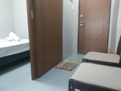 a small room with a door and a bed and a drawer at Monteluce 2 BR LOFT with pool 825 in Silang