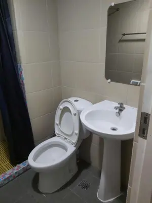 a bathroom with a toilet and a sink at Monteluce 2 BR LOFT with pool 825 in Silang