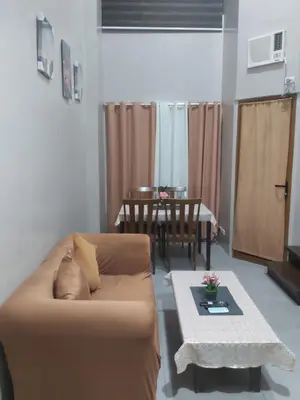 a living room with a couch and a table at Monteluce 2 BR LOFT with pool 825 in Silang