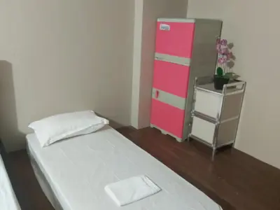a small bedroom with a pink dresser and a bed at Monteluce 2 BR LOFT with pool 825 in Silang
