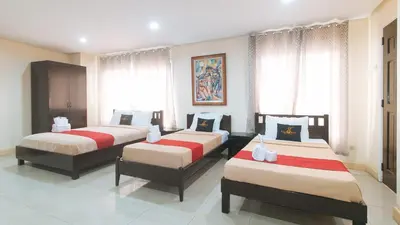 three beds in a room with windows at 153 Silverio Suites Paranaque City in Manila
