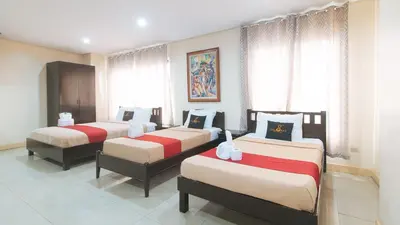 a bedroom with three beds in a room at 153 Silverio Suites Paranaque City in Manila