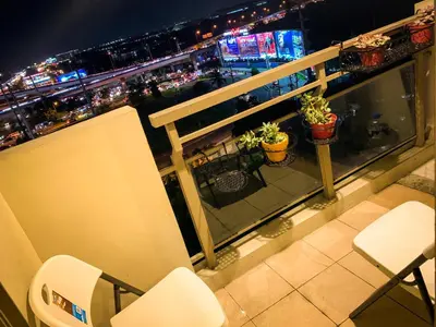 a balcony with a view of a city at night at Ramiro Haven Staycation in Manila