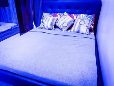 a blue bed with pillows on top of it at Ramiro Haven Staycation in Manila