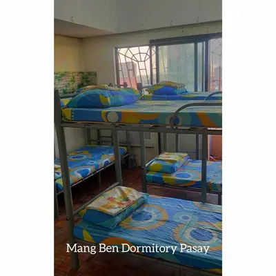 a group of bunk beds in a room at Mang Ben Dormitory Pasay in Manila