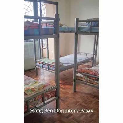 a group of bunk beds in a room at Mang Ben Dormitory Pasay in Manila