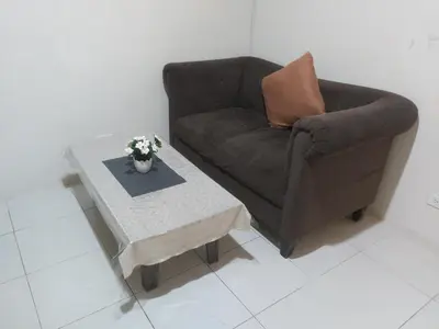 a living room with a chair and a coffee table at Affordable Tagaytay Monteluce 1BR with Pool G10 in Lalaan Primero