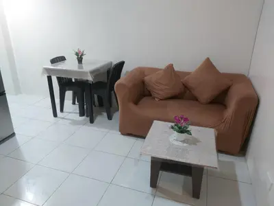 a living room with a couch and a table at Affordable Tagaytay Monteluce 1 BR WITH POOL-224 in Lalaan Primero
