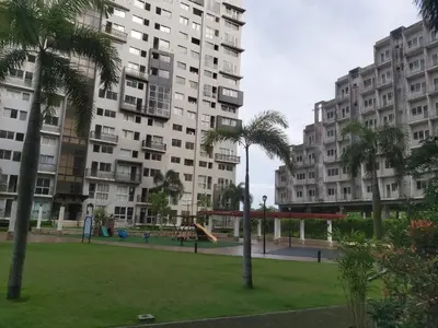 a park with a playground in front of tall buildings at Affordable Tagaytay Monteluce 1 BR WITH POOL-224 in Lalaan Primero