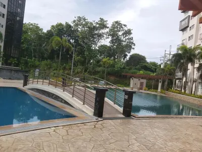 a bridge over a swimming pool in a building at Affordable Tagaytay Monteluce 1 BR WITH POOL-224 in Lalaan Primero