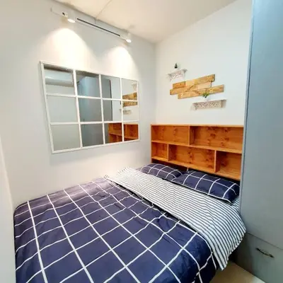 a bedroom with a blue bed and a window at S Residences MOA Condo Stunning Boutique Hotel Type T1 in Manila
