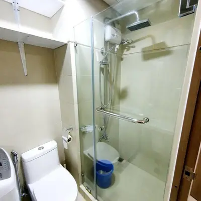 a bathroom with a glass shower with a toilet at S Residences MOA Condo Stunning Boutique Hotel Type T1 in Manila
