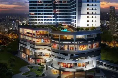 a large building with lights on in a city at Air Residences Makati Condo Elegant Grand Hotel Type in Manila