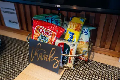 a basket filled with snacks and a sign that says thanks at Shell Residences Pasay 1BR Walk to MOA Newly Renovated! in Manila