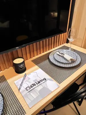 a table with a plate and a glass of wine at Shell Residences Pasay 1BR Walk to MOA Newly Renovated! in Manila