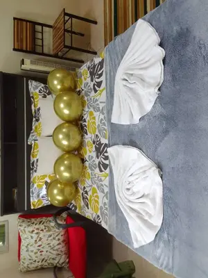 a bed with a bunch of green balls on it at Aliyahs Place in Cainta