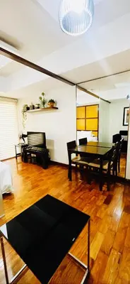 a living room with a ping pong table and chairs at Mosaic Tower in Manila