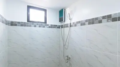 a bathroom with a shower with a window at RedDoorz near UST Sampaloc Manila in Manila
