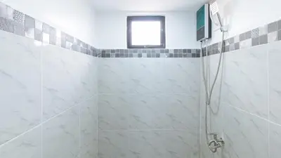 a bathroom with a shower with a window at RedDoorz near UST Sampaloc Manila in Manila