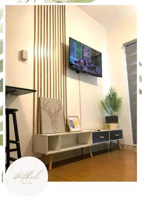 a living room with a tv on a wall at Bethel House in Manila