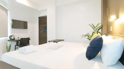 a white room with a bed and a tv at UrbanView at San Antonios Place Sampaloc Manila in Manila