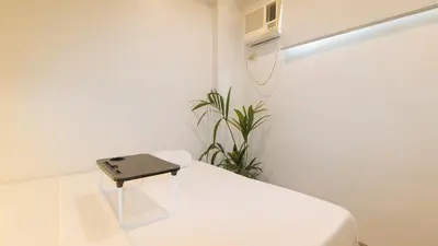 a hospital room with a bed and a air conditioner at UrbanView at San Antonios Place Sampaloc Manila in Manila