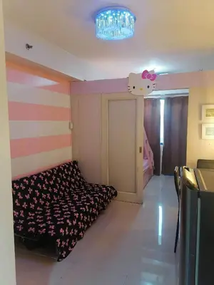 a room with a bed with a hello kitty on the wall at Blue's Residences in Manila
