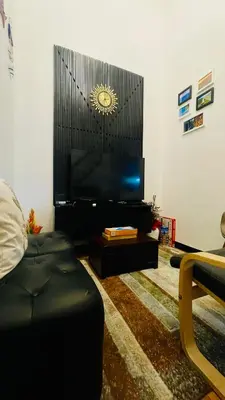a living room with a flat screen tv on a wall at Modern Condotel Stay with Netflix, Kitchen & Washer, Near MRT Boni in Manila