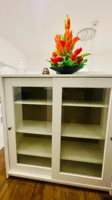 a bowl of flowers on top of a white cabinet at Modern Condotel Stay with Netflix, Kitchen & Washer, Near MRT Boni in Manila
